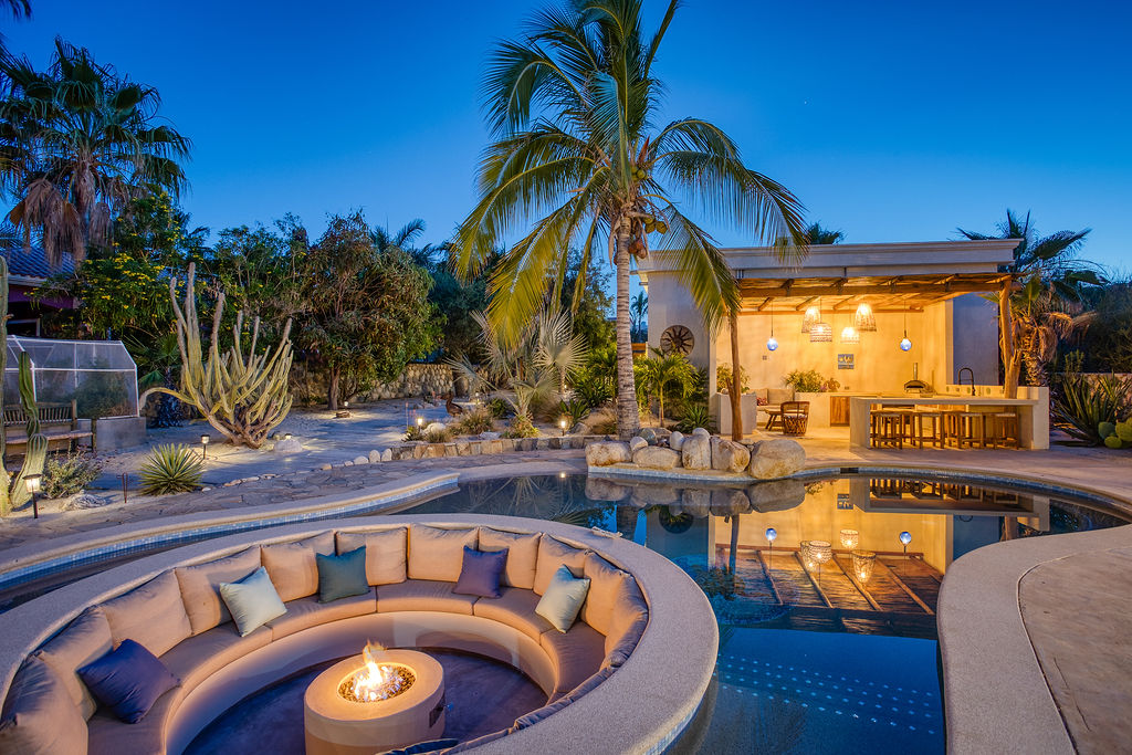 Courtyard pool with fire pit lounge at dusk